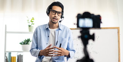 Asian school male teacher working from home teaching online math subject to student studying from home. Man using camera to record his live on internet. Remote education class during covid19 pandemic.